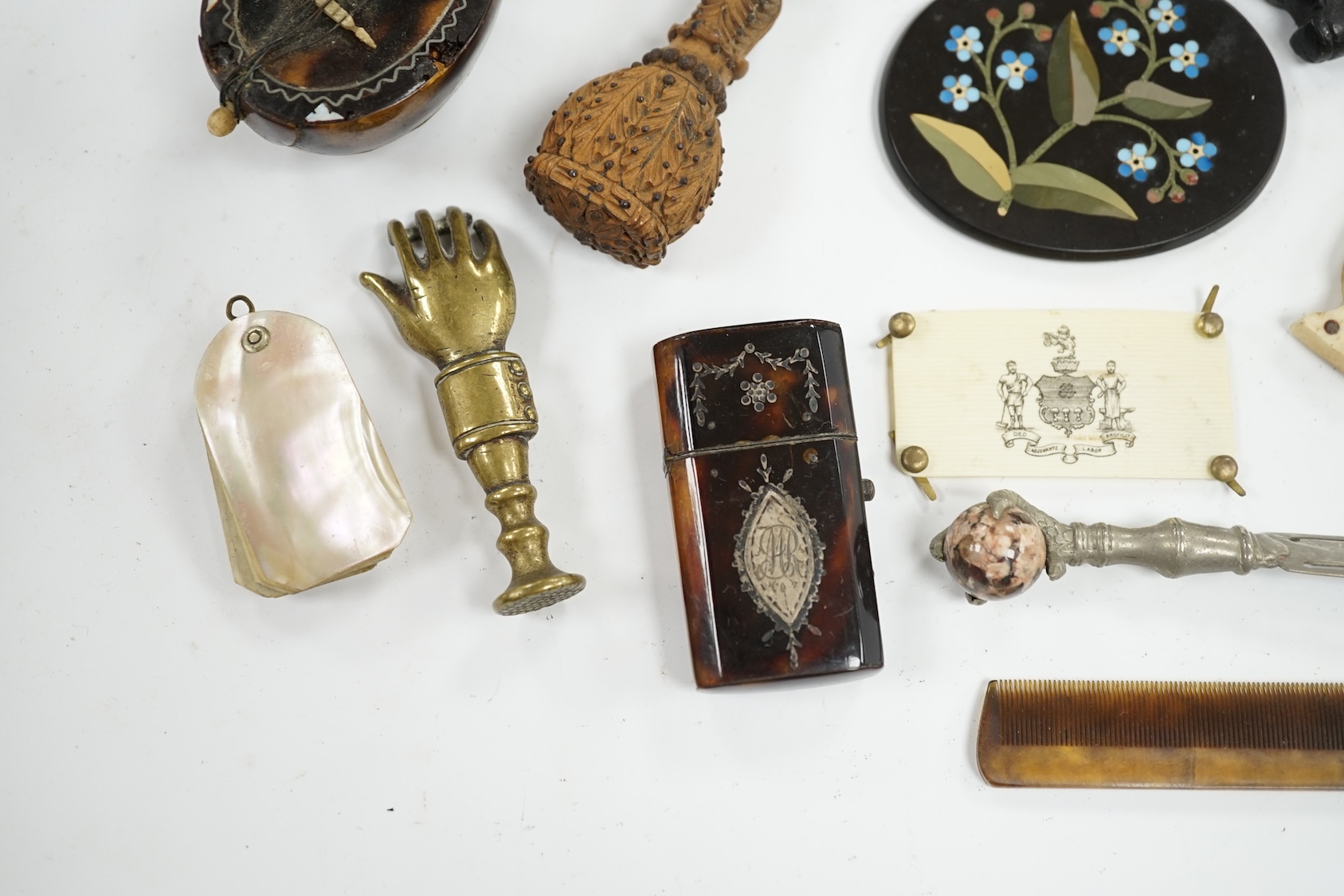 Miscellaneous objects of vertu including a pair of carved wood boots, an inlaid tortoiseshell needle case, a carved mother of pearl box and a pietra dura oval floral panel, largest 12.5cm in length. Condition - mostly fa